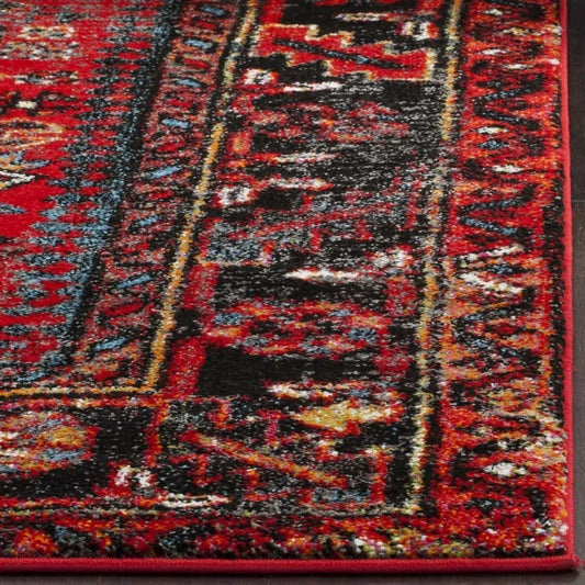 Close-up of red Persian rug showing intricate floral and vine motifs in cream, blue, and burgundy tones