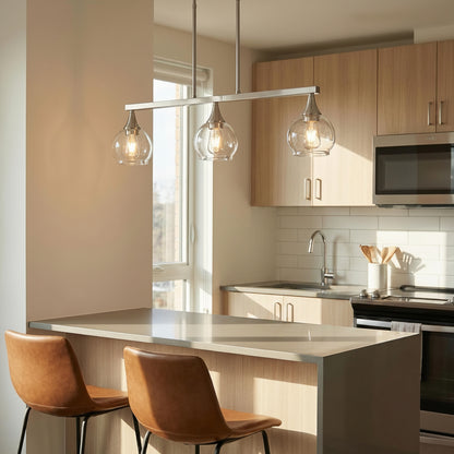 Woman sitting at a kitchen counter with modern pendant lights and a view of the city.