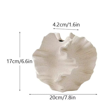 Two beige ceramic coral vases (one large, one small) displayed together on a shelf