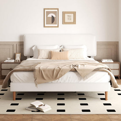A modern white platform bed with a tall upholstered headboard, styled with beige and white bedding, wooden nightstands, framed wall art, and a black-and-white checkered rug in a neutral bedroom setting.
