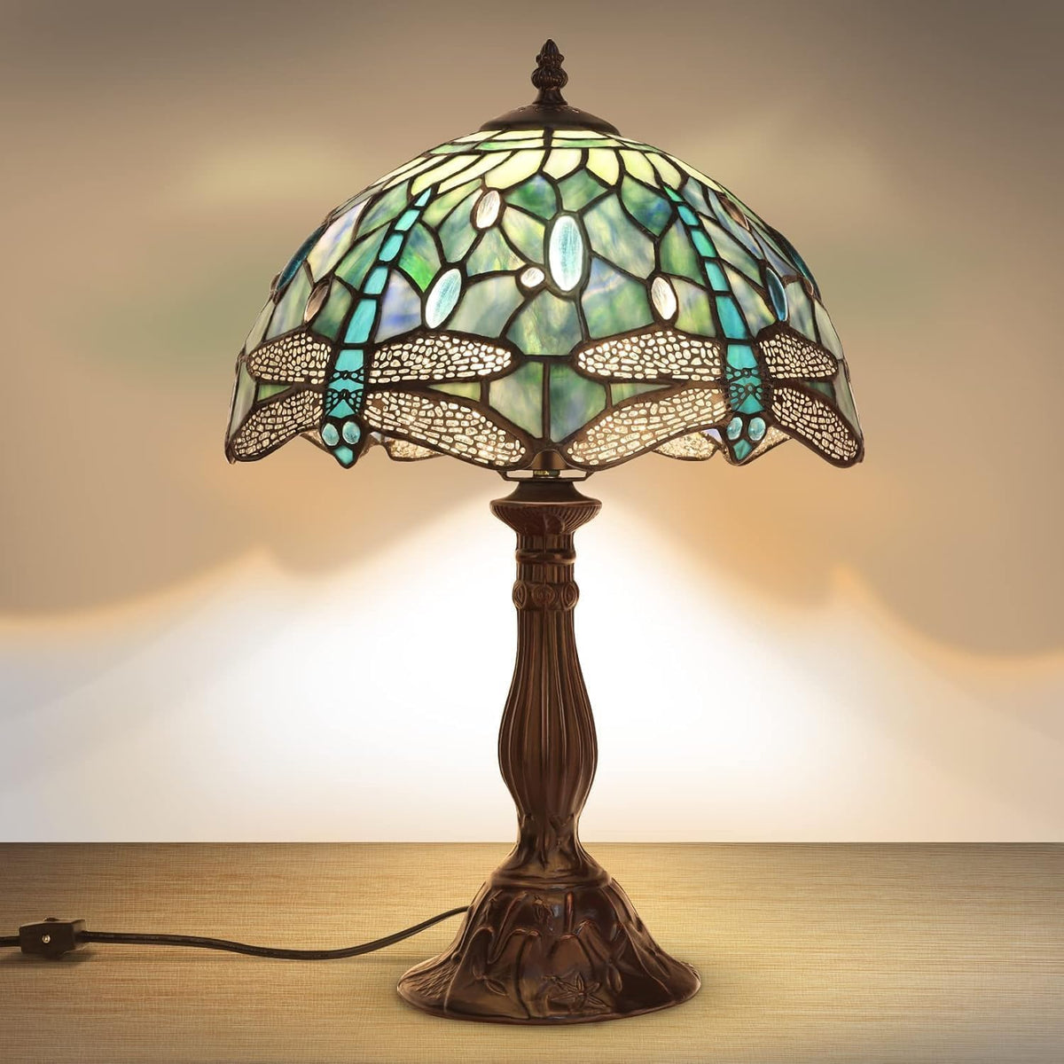 Tiffany-style table lamp with stained glass shade on a wooden surface.