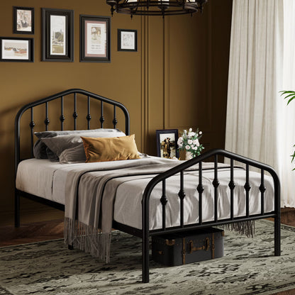 A black metal bed frame with spindle-style headboard and footboard bars, shown in a styled bedroom setting with bedding, pillows, framed wall art, curtains, and a patterned rug.