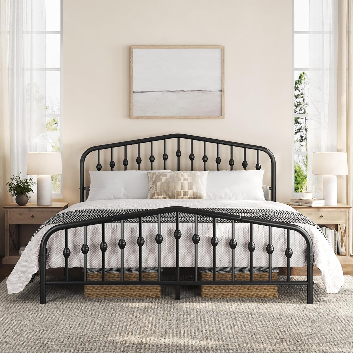 Black metal bed frame in a bedroom setting with white bedding and decor.
