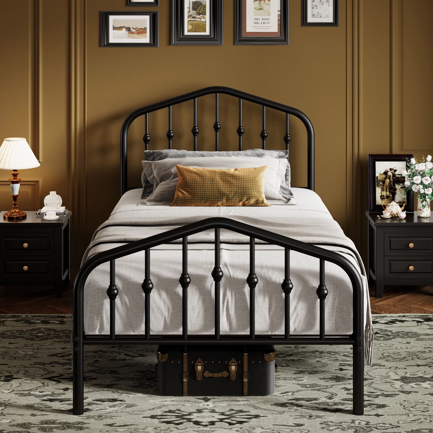 A black metal bed frame with a decorative spindle headboard and footboard, styled with white and gray bedding and a mustard yellow accent pillow in a brown paneled bedroom.