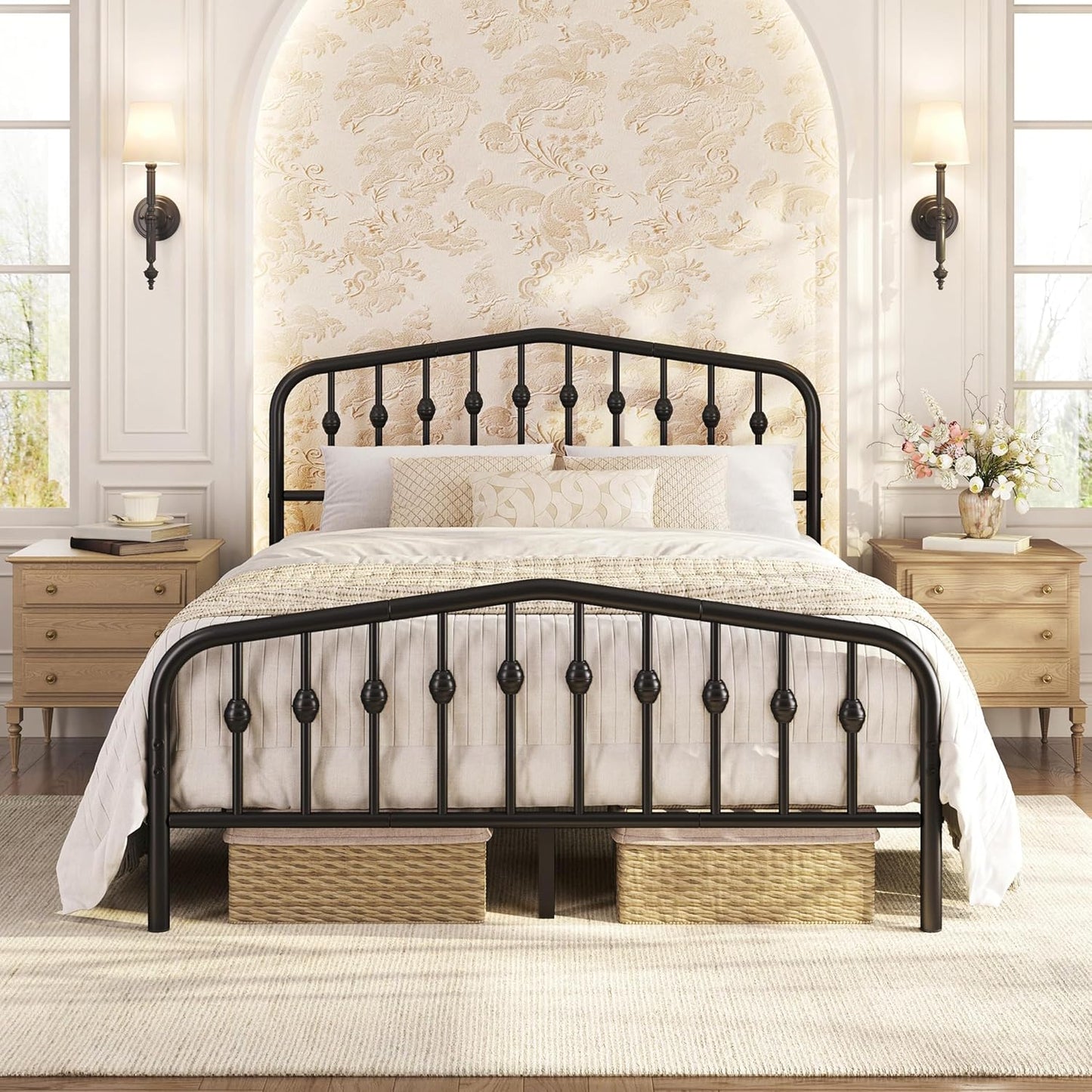 A black metal bed frame with a decorative spindle headboard and footboard, styled with white bedding in a bright, classic bedroom setting.