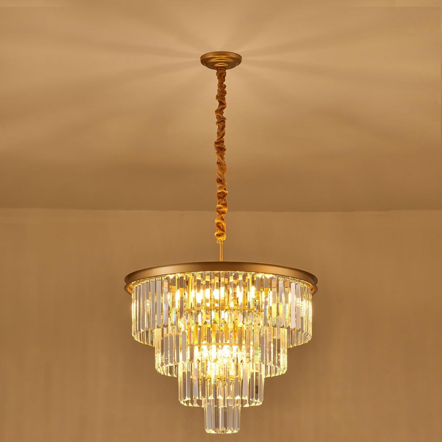 Gold chandelier with clear crystals on a beige background