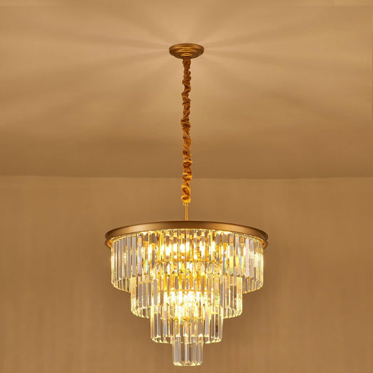 Gold chandelier with clear crystals on a beige background