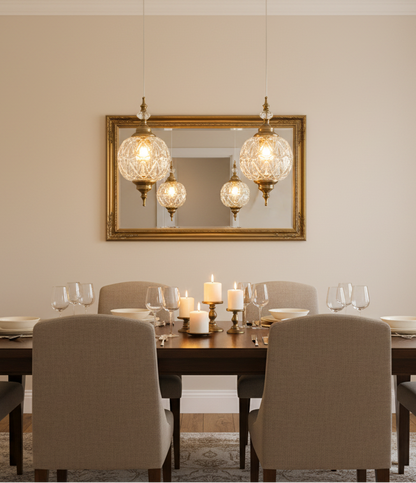 Dining room with a table set for four, candles, and a mirror with decorative lights.