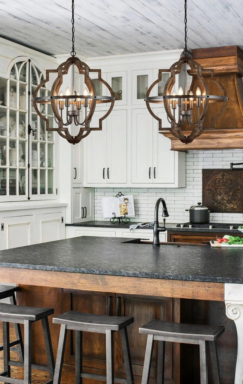 Modern kitchen with white cabinets, black countertops, and wooden island.