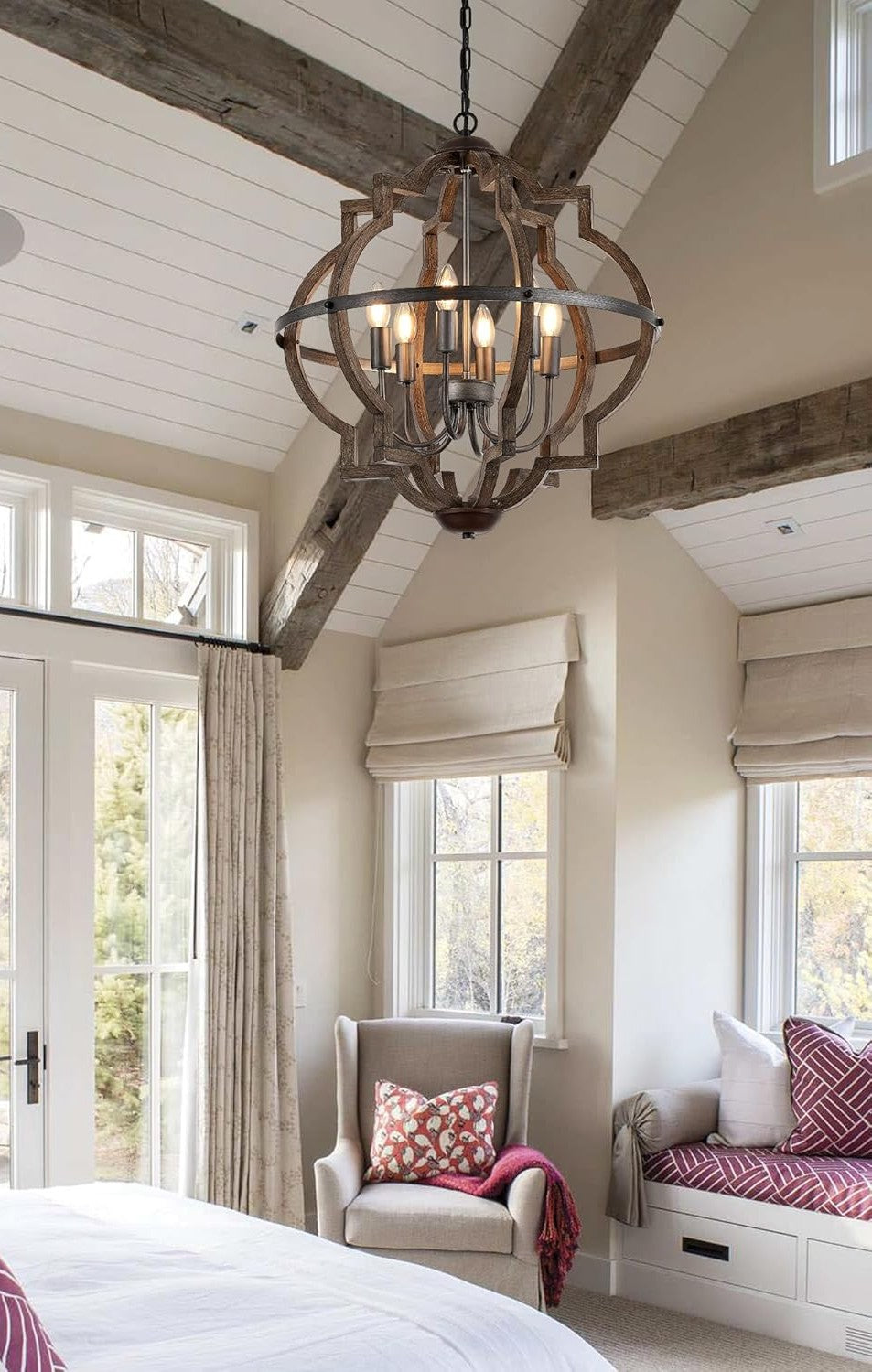 Cozy bedroom with a chandelier, armchair, and window seat.