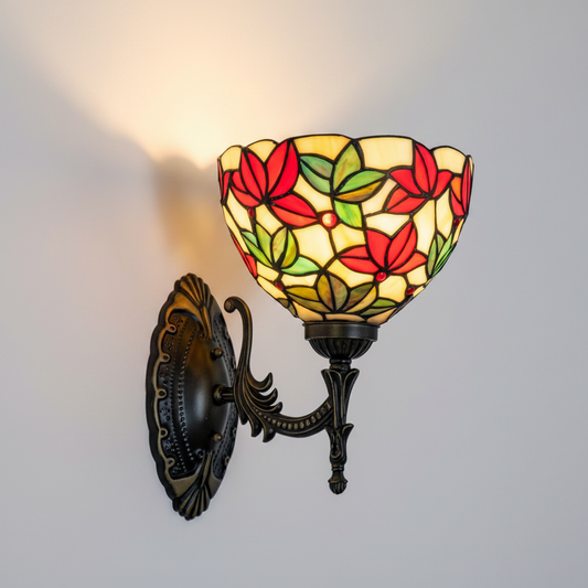 Decorative wall sconce with stained glass shade featuring red and green leaves on a white background