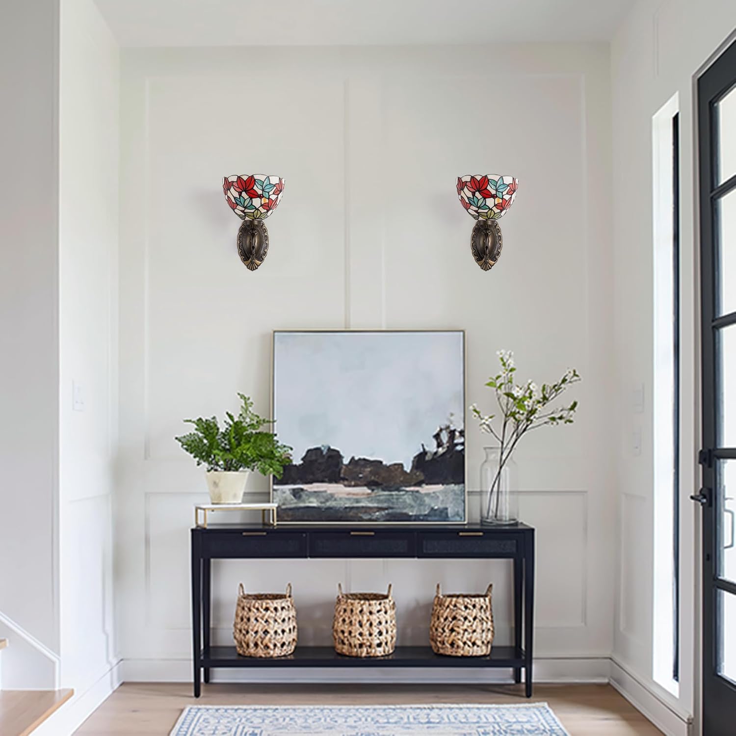 Modern interior with a black console table, decorative items, and wall sconces.