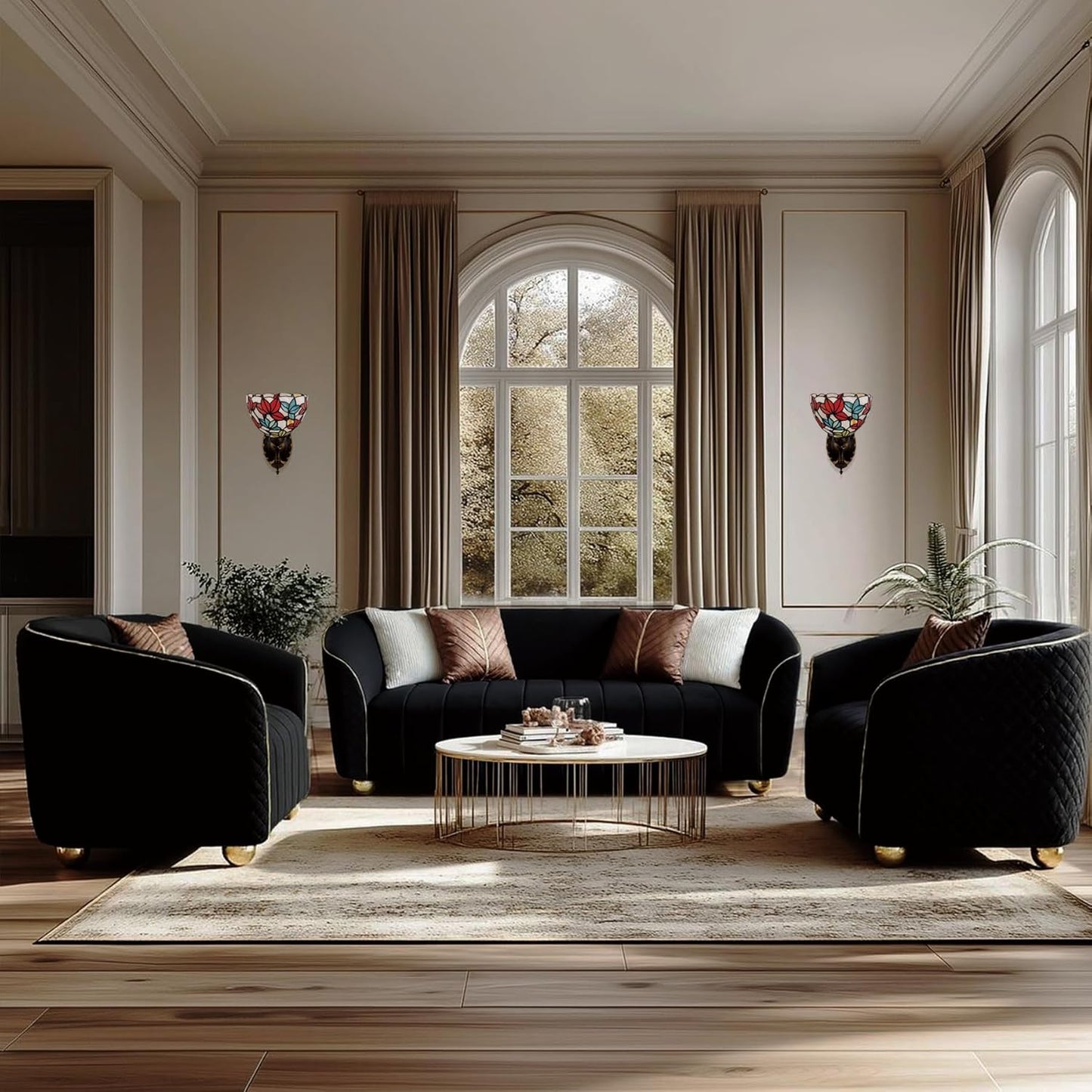 Modern living room with black sofa and armchairs, coffee table, and decorative elements.