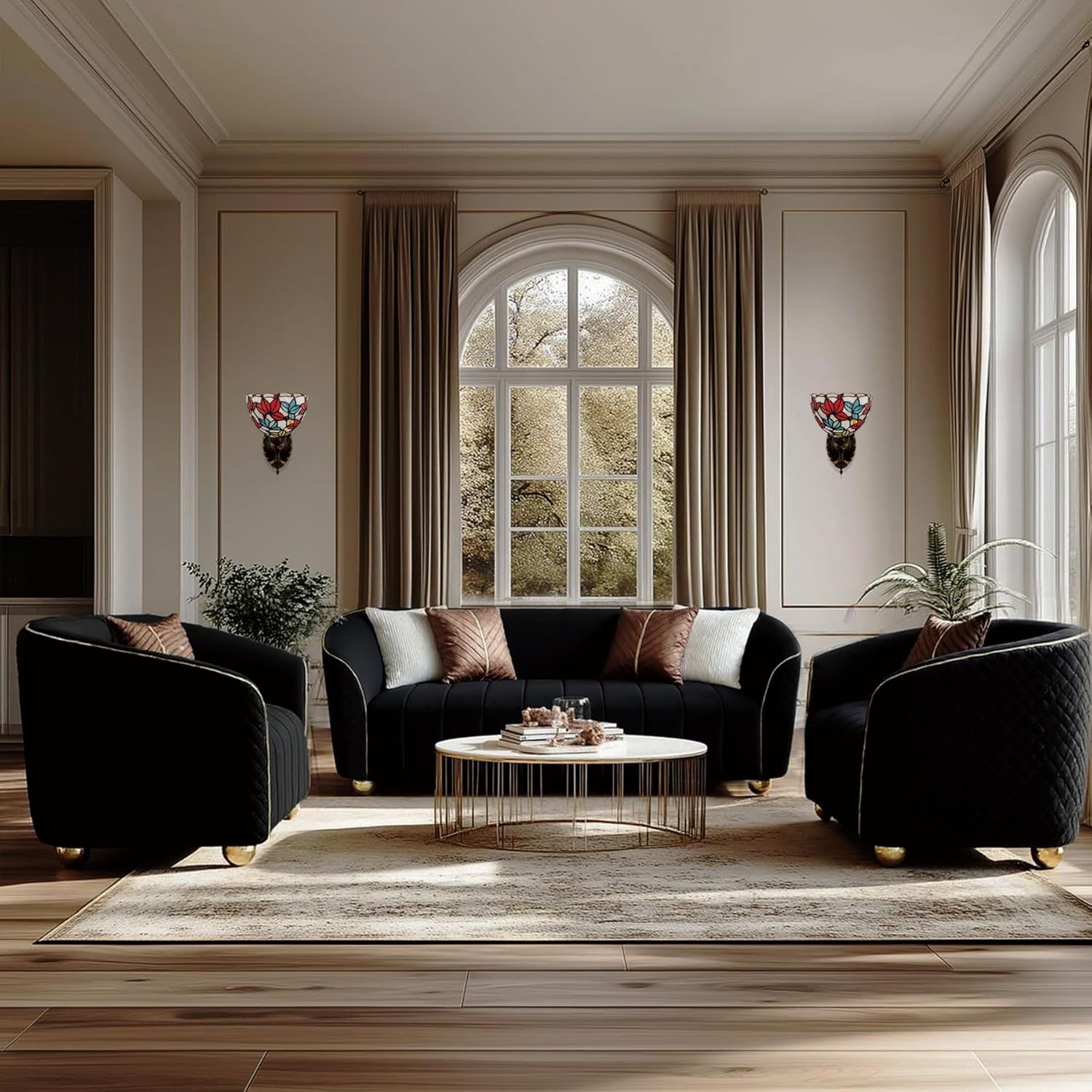 Modern living room with black sofa and armchairs, coffee table, and decorative elements.