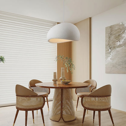 A modern dining room scene featuring a round wooden table with a woven pedestal base, surrounded by four woven-back chairs with beige upholstered seats. A large white dome pendant light hangs above, and a black Fivemengo logo overlay is visible in the top-left corner.