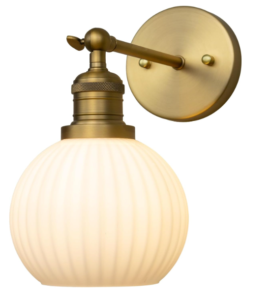 Brass wall sconce with a glass shade on a white background