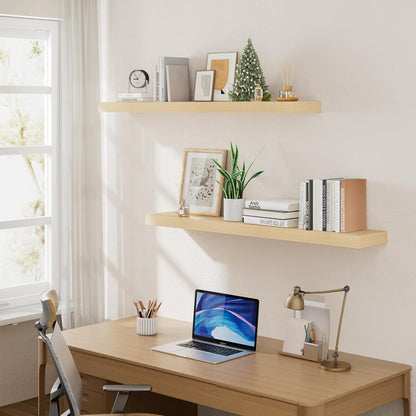 Home office setup with a desk, laptop, and shelves with decor items.