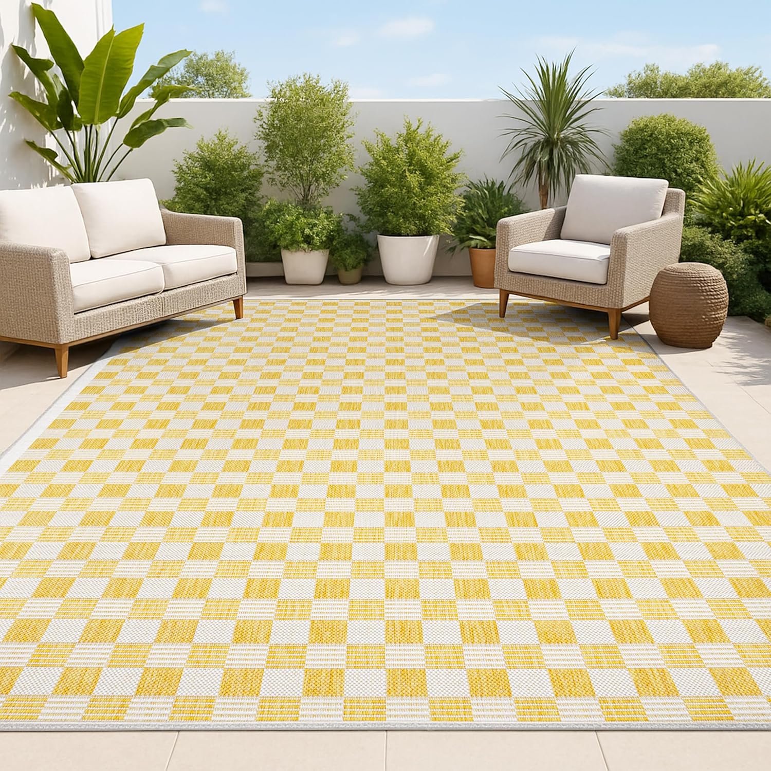 Yellow and white checkered rug on a patio with outdoor furniture and plants.