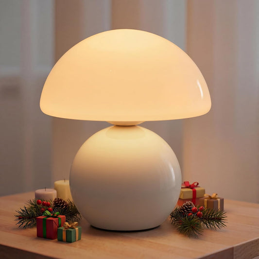 White table lamp on a wooden surface with decorative items and candles.