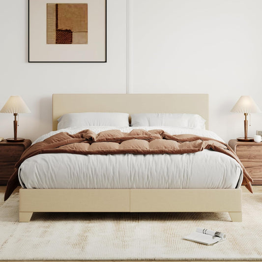 Beige bed with white bedding and brown comforter in a bedroom setting.