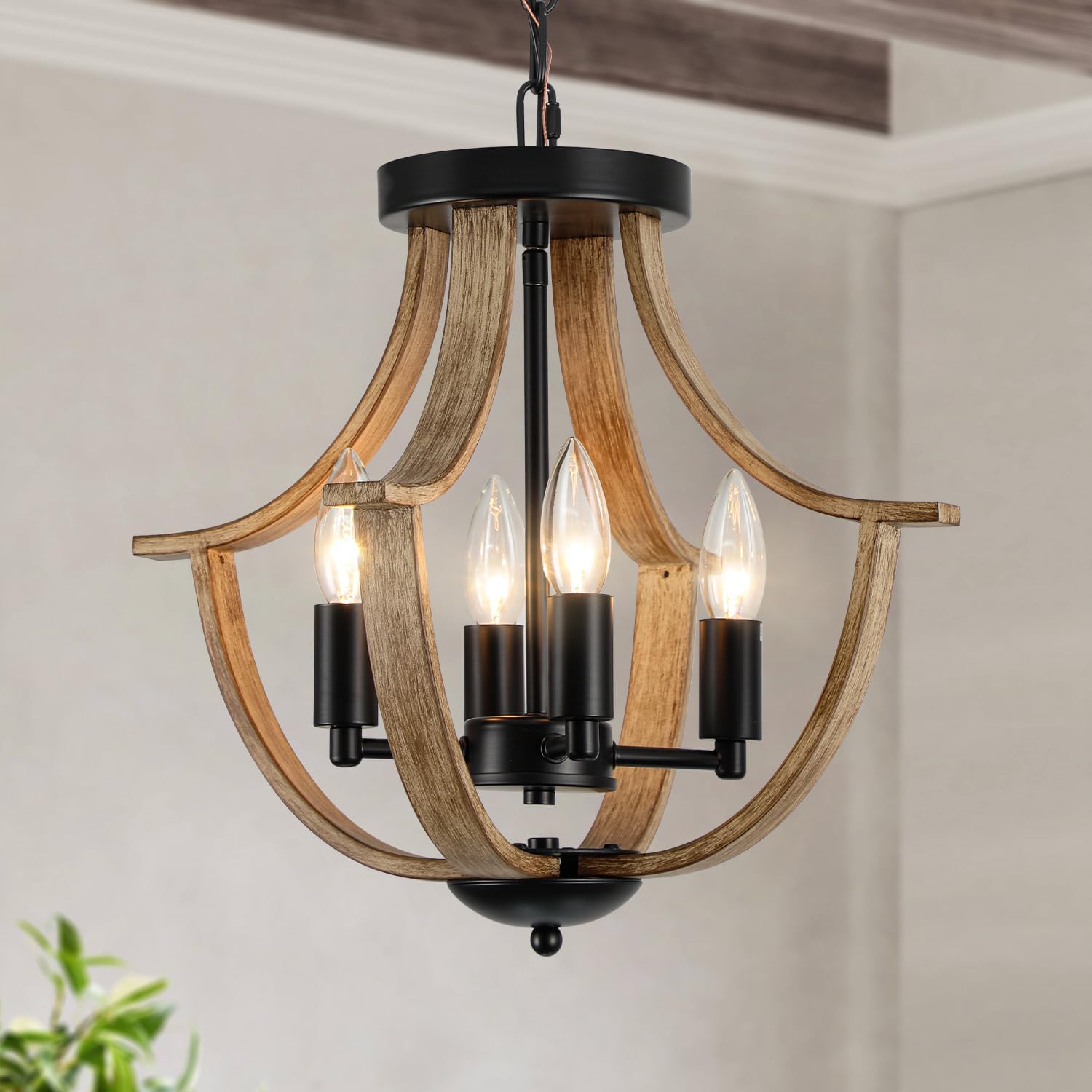 Wooden chandelier with black accents hanging against a neutral wall.