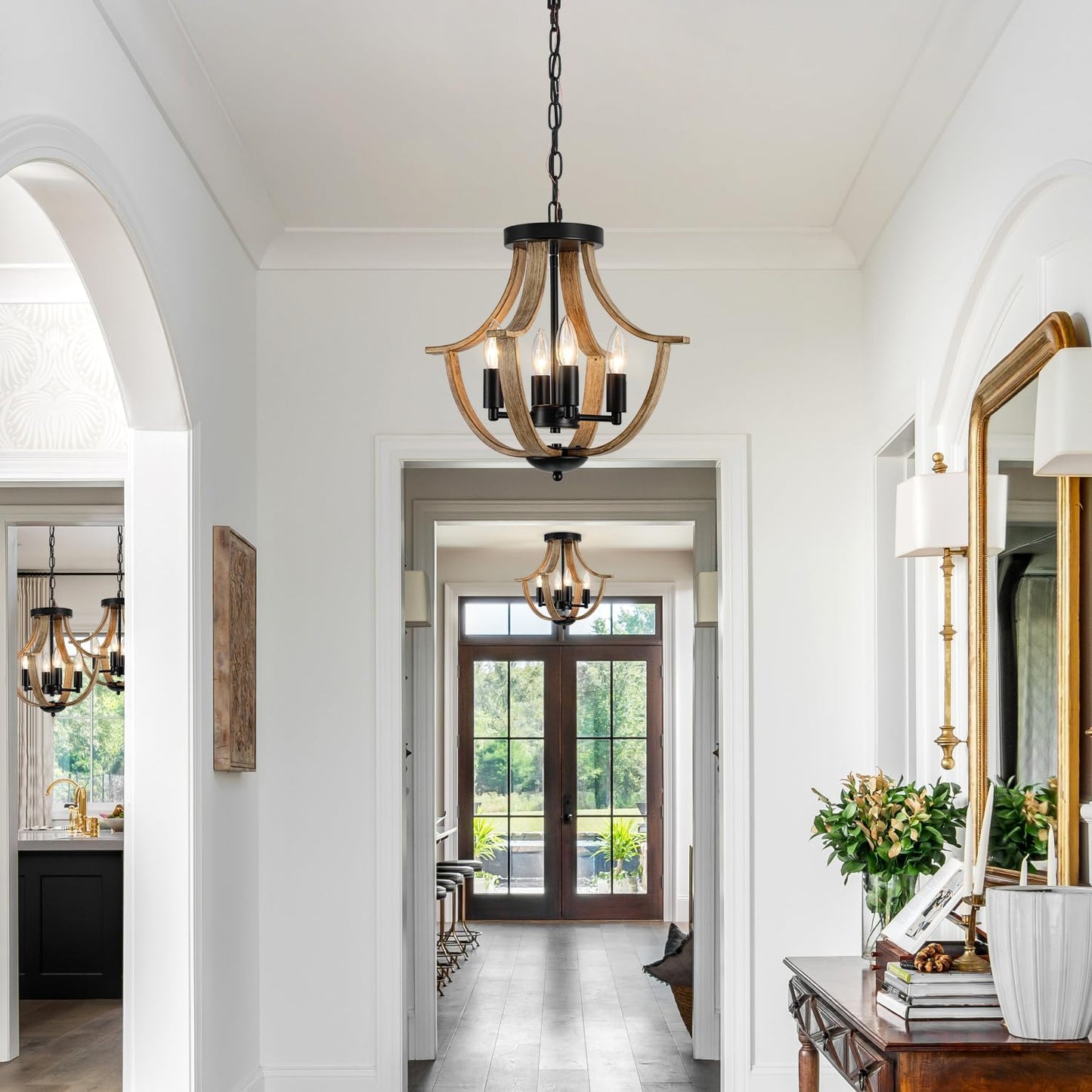 Elegant hallway with chandeliers, mirrors, and decorative items.