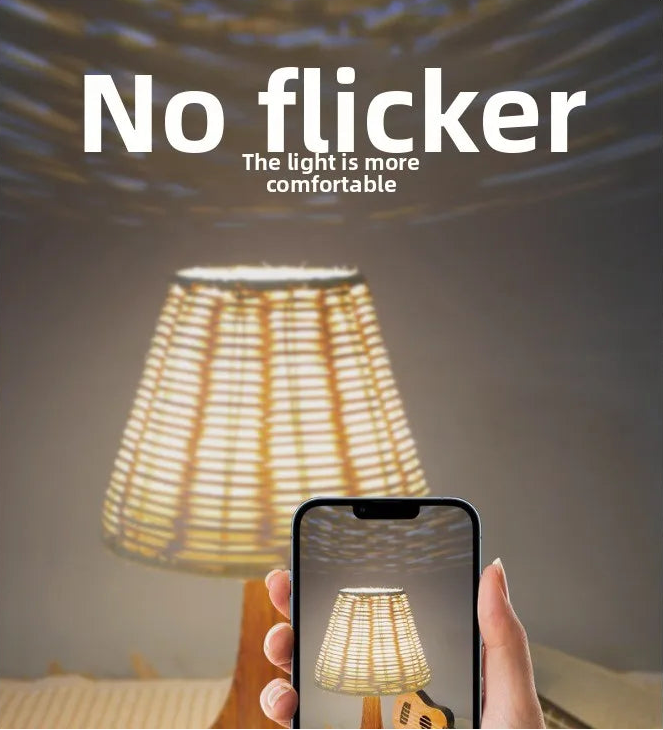 Person holding a smartphone with a lamp displayed on the screen, with text 'No flicker' and 'The light is more comfortable'.