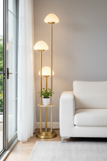 Gold floor lamp with a plant in a living room setting