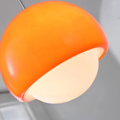 Ceiling-mounted Crystal Glow Pendant Lamp lights in vibrant orange hue.